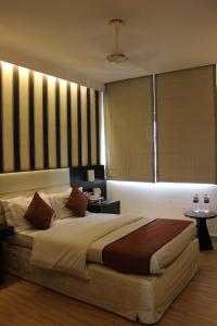 מיטה או מיטות בחדר ב-Hotel Jukaso Inn Down Town