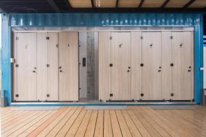 a row of lockers in a gym with a wooden floor at Liuqiu Dive Hostel in Xiaoliuqiu