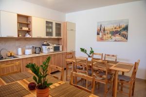 a kitchen and dining room with a table and chairs at Anna Vendégház Tarcal in Tarcal