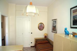 a living room with a couch and a chandelier at Delizia apartment in Rapallo