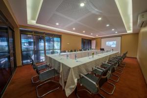 a large conference room with a long table and chairs at Dolphin Suites in Kampala