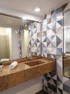 a bathroom with a large sink and a mirror at Bahia Pelô Hostel in Salvador +60 photos