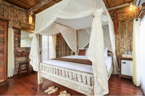 מיטה או מיטות בחדר ב-Royal JJ Ubud Resort & Spa