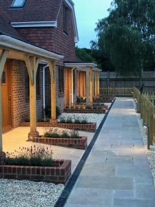 a house with a walkway in front of a house at Hamilton Arms Suites in Midhurst