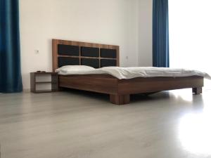 a bedroom with a large bed with a wooden headboard at Casa EVA in Panaci