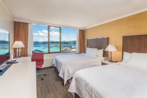 a hotel room with two beds and a large window at Coast Discovery Inn in Campbell River