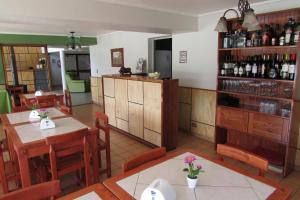 a restaurant with tables and chairs and a bar at Hotel Los Andes in Los Andes