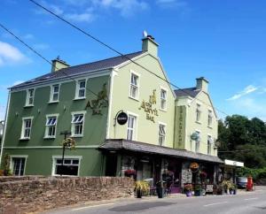 a green building on the side of a street at The Anvil Bar B&B in Castlemaine