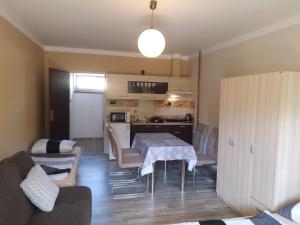 a kitchen and a living room with a table and a couch at Penzion Burda in Žehrov