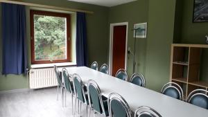 a conference room with a table and chairs at Le Moulin Lemaire in Houffalize
