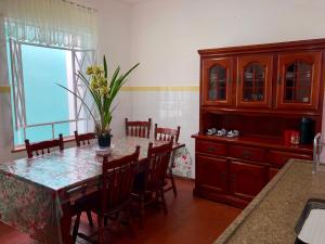 a dining room with a table and chairs and a window at Pousada Monte Alegre in São Paulo