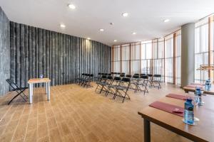 a large room with tables and chairs and windows at ​Exe Las Margas Golf in Latas