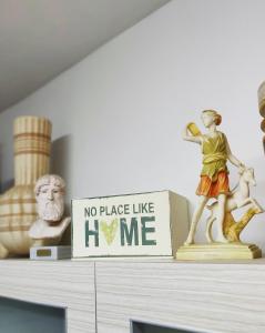 a no place like home sign on top of a dresser at Marina's Home By The Sea in Bat Yam