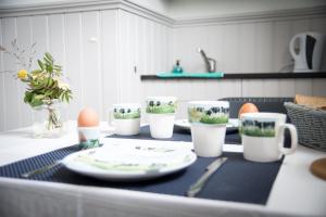 a table with plates and cups and eggs on it at Kerkovernachting in Schettens