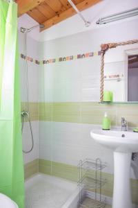a bathroom with a sink and a shower at Elina's easygoing place in Mantoúkion