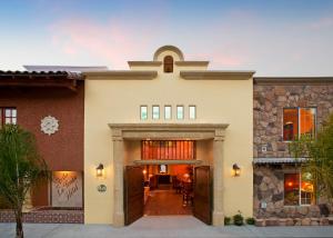 a home with a large entryway and a building at Avila La Fonda Hotel in Avila Beach