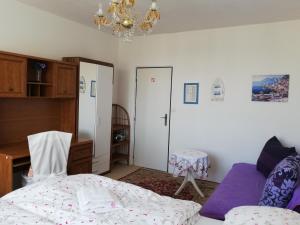 a bedroom with a bed and a chandelier at Apartments Meixner in Mariánské Lázně