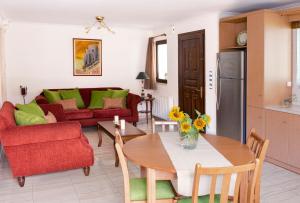 a kitchen and a living room with a table and chairs at Apartment in Peania (15min from Airport) in Paianía