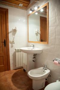 a bathroom with a sink and a mirror and a toilet at Turisme Rural Lo Pallé de Cal Bosch in Llagunes +93 photos