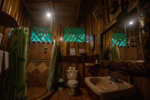a bathroom with a tub and a sink at Hotel La Costa de Papito in Puerto Viejo