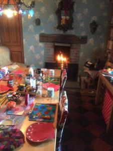 a dining room with a table and a fireplace at Western House in Llangennith