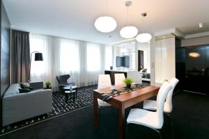 a living room with a table and chairs and a couch at Hotel Martina in Żnin
