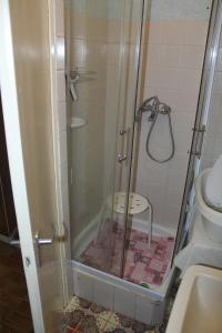 a shower with a glass door in a bathroom at Casa Mamma in Budapest