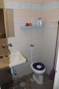 a bathroom with a toilet and a sink at Casa Mamma in Budapest +9 photos