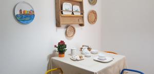 a table with a white table cloth on it at Le pavoncelle blu in Nuoro