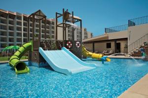 a pool with a water slide in a resort at Krystal Grand Los Cabos - All Inclusive in San José del Cabo
