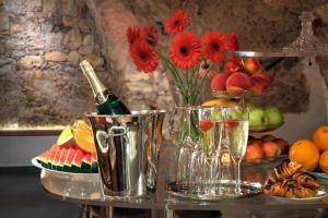 a table with a bottle of champagne and some fruit at Hotel Waldstein in Prague