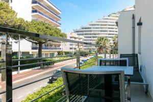 a balcony with a table and a view of a street at Villa Azur in Villeneuve-Loubet