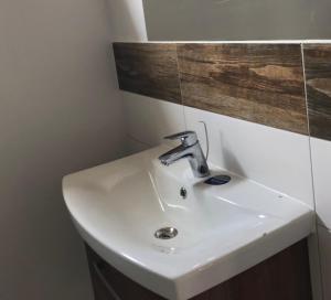 a white sink in a bathroom with a mirror at Merinn in Rogowo +31 photos