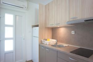 a kitchen with a sink and a counter top at Studio apartment - seaview in Premantura