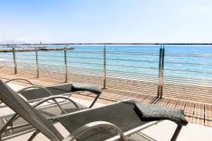 a balcony with chairs and a view of the ocean at Villa Azur in Villeneuve-Loubet