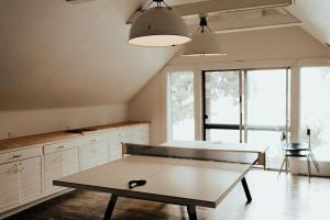 a ping pong table in the middle of a room at The Suttle Lodge & Boathouse in Camp Sherman