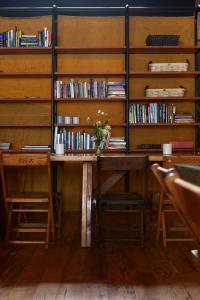 a desk with a vase of flowers on it in a library at The Suttle Lodge & Boathouse in Camp Sherman +54 photos