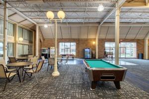 a pool table in a room with tables and chairs at Radisson Hotel and Conference Center Fond du Lac in Fond du Lac