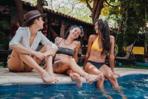three women sitting in the water at a swimming pool at Dreamer Santa Marta in Santa Marta
