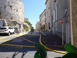 a street with a yellow hose on the side of a building at 6 rue de la tourraque in Antibes