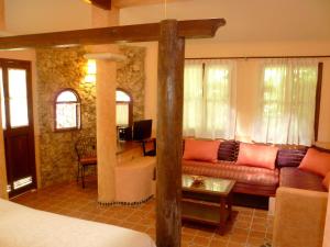 a living room with a couch and a table at Hacienda Hotel Santo Domingo in Izamal