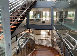 a spiral staircase in a building with glass floors at Riellis Center Hotel in Botucatu