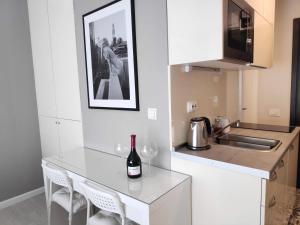 a kitchen with a counter with a bottle of wine on it at Penthouse “Sky 16” Studio Apartment in Zagreb