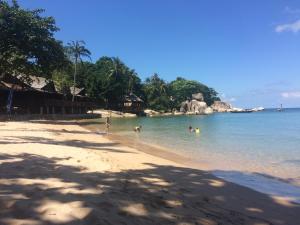 a group of people playing in the water on a beach at Hotel4U Koh Tao in Ko Tao