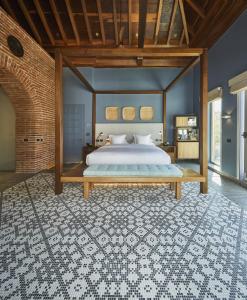 a bedroom with a large bed with a wooden frame at Hotel Boutique Casona del Colegio in Cartagena de Indias