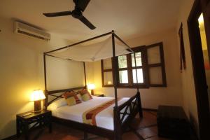 
A bed or beds in a room at Mysteres D'angkor Siem Reap Lodge
