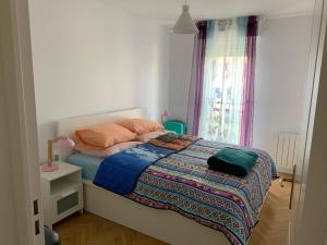 a bedroom with a bed and a window at La Défense wonderful 2 bedrooms apartment in Suresnes