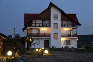 a large white house with lights in front of it at Poème in Sighetu Marmaţiei