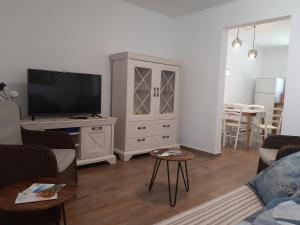 a living room with a tv and a entertainment center at House Marija island Krk in Punat