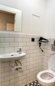 a bathroom with a toilet and a sink and a mirror at Axel Hotel Moscow in Moscow